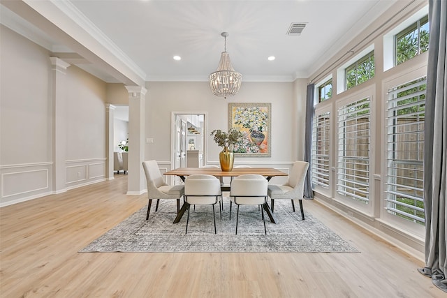 1405 Blueberry Ln, Friendswood, TX 77546 - dining area with light wood-style floors, crown molding, a chandelier, ornate columns, and recessed lighting