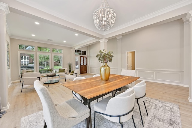 1405 Blueberry Ln, Friendswood, TX 77546 - dining room featuring ornate columns, crown molding, recessed lighting, a decorative wall, and light wood-type flooring