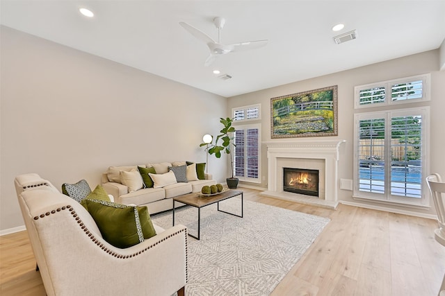 1405 Blueberry Ln, Friendswood, TX 77546 - living room with wood finished floors, a ceiling fan, baseboards, a warm lit fireplace, and recessed lighting