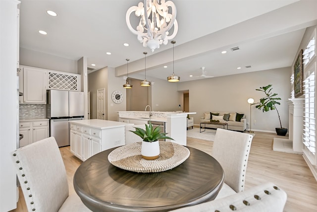 1405 Blueberry Ln, Friendswood, TX 77546 - dining room with light wood finished floors, a chandelier, healthy amount of natural light, recessed lighting, and baseboards