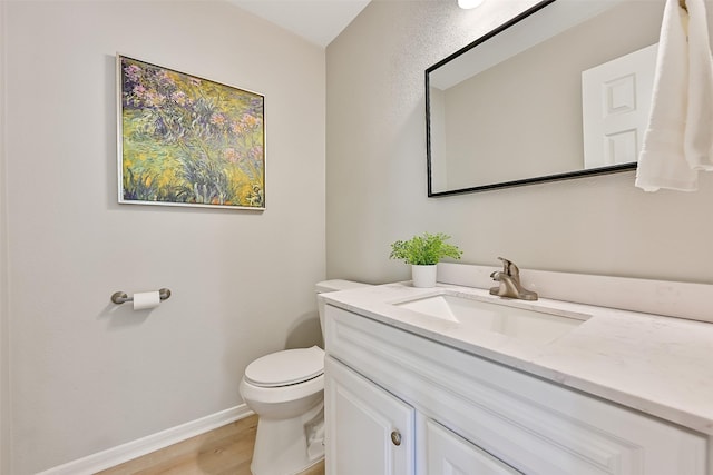 1405 Blueberry Ln, Friendswood, TX 77546 - half bathroom with toilet, wood finished floors, vanity, and baseboards