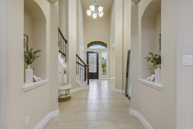 16815 Bornish Hill Ct, Humble, TX 77346 - foyer entrance with a chandelier, stairway, a high ceiling, baseboards, and arched walkways