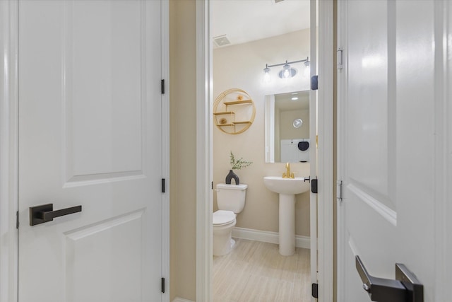 16815 Bornish Hill Ct, Humble, TX 77346 - half bath with toilet, baseboards, and a sink