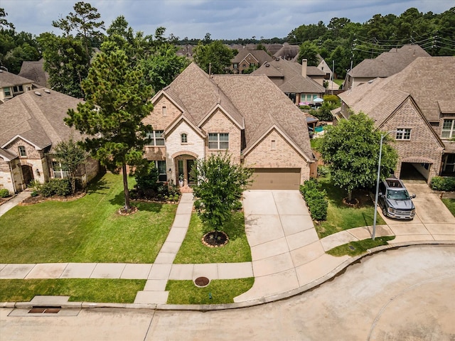 16815 Bornish Hill Ct, Humble, TX 77346 - french country style house with concrete driveway, a front yard, a residential view, and stone siding