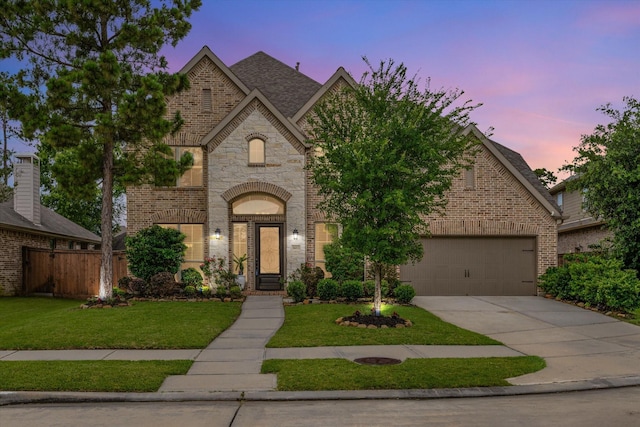 16815 Bornish Hill Ct, Humble, TX 77346 - view of front facade with driveway, brick siding, a garage, and stone siding