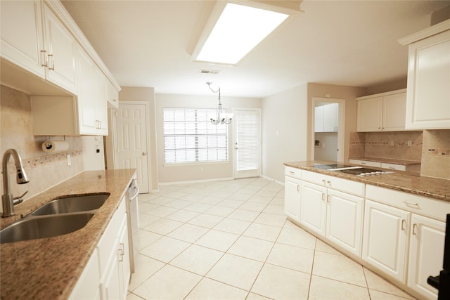 14106 Glen Canon Ln, Houston, TX 77069 - kitchen featuring a sink, tasteful backsplash, light tile patterned floors, a chandelier, and baseboards