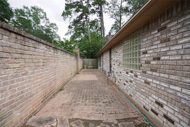 14106 Glen Canon Ln, Houston, TX 77069 - view of property exterior with a fenced backyard, a chimney, a patio area, and brick siding