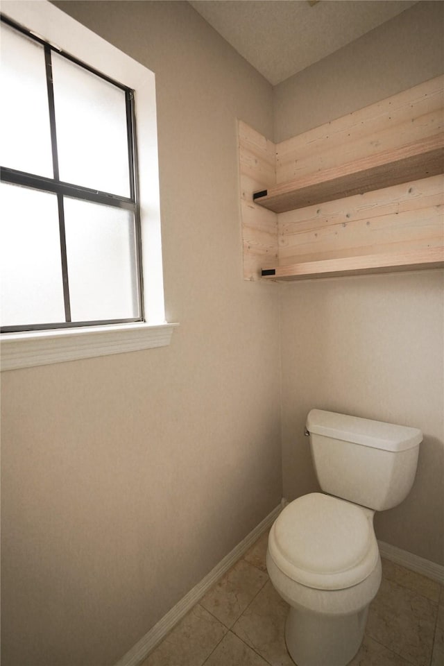 14106 Glen Canon Ln, Houston, TX 77069 - bathroom with baseboards, toilet, and tile patterned floors