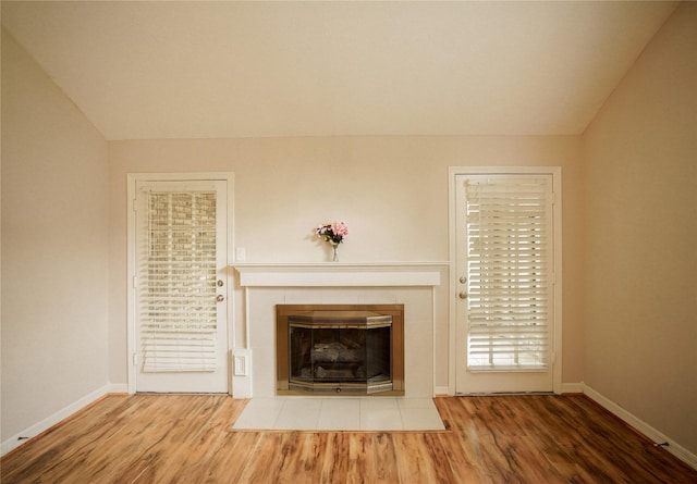 14106 Glen Canon Ln, Houston, TX 77069 - detailed view of wood finished floors, baseboards, and a tile fireplace