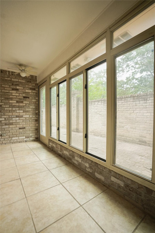 14106 Glen Canon Ln, Houston, TX 77069 - unfurnished sunroom featuring brick wall and tile patterned flooring