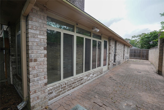 14106 Glen Canon Ln, Houston, TX 77069 - view of side of home with brick siding and a patio area