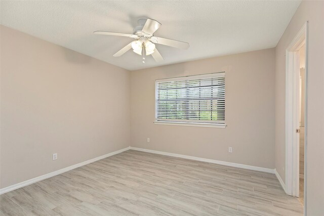 14106 Glen Canon Ln, Houston, TX 77069 - unfurnished room featuring light wood finished floors, baseboards, and ceiling fan