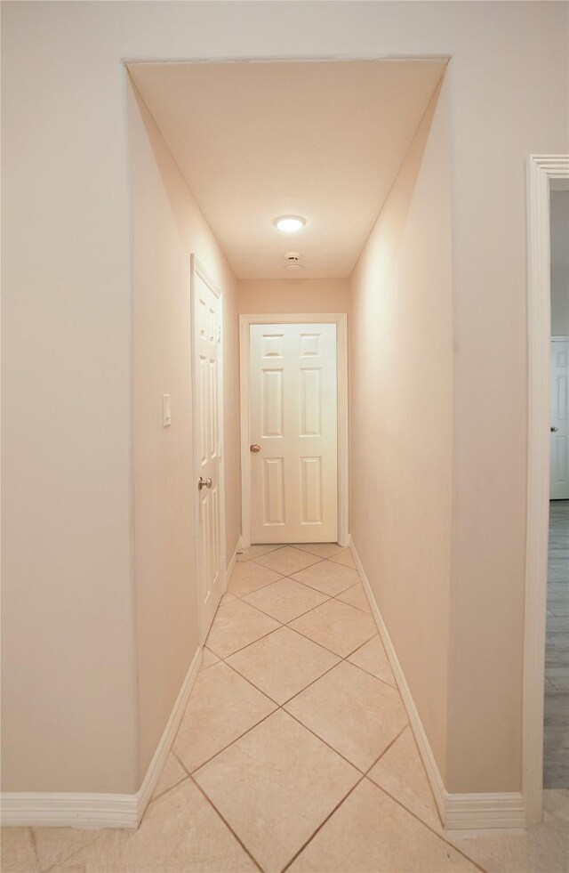 14106 Glen Canon Ln, Houston, TX 77069 - hallway with light tile patterned floors and baseboards