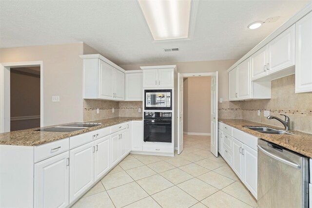 14106 Glen Canon Ln, Houston, TX 77069 - kitchen featuring black appliances, a sink, decorative backsplash, and white cabinets