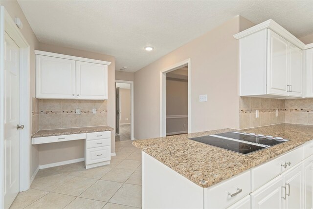 14106 Glen Canon Ln, Houston, TX 77069 - kitchen featuring black electric cooktop, tasteful backsplash, light tile patterned floors, white cabinets, and recessed lighting