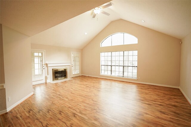 14106 Glen Canon Ln, Houston, TX 77069 - unfurnished living room featuring a ceiling fan, wood finished floors, lofted ceiling, a fireplace, and baseboards