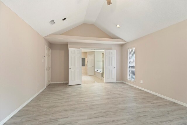 14106 Glen Canon Ln, Houston, TX 77069 - empty room featuring vaulted ceiling, baseboards, light wood-style flooring, and recessed lighting