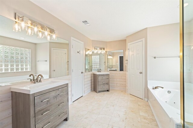 14106 Glen Canon Ln, Houston, TX 77069 - bathroom featuring two vanities and a tub with jets