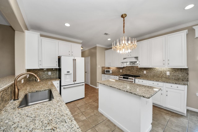 20902 Montana Bend Ln, Cypress, TX 77433 - kitchen featuring white appliances, a sink, under cabinet range hood, crown molding, and tasteful backsplash