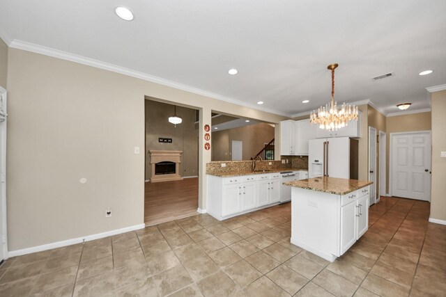 20902 Montana Bend Ln, Cypress, TX 77433 - kitchen featuring white appliances, a chandelier, light tile patterned floors, tasteful backsplash, and a fireplace