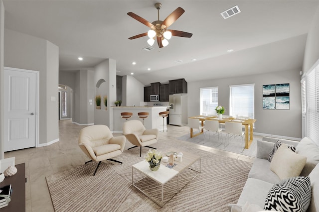 115 Clear Water St W, Montgomery, TX 77356 - living room with lofted ceiling, ceiling fan, arched walkways, recessed lighting, and baseboards