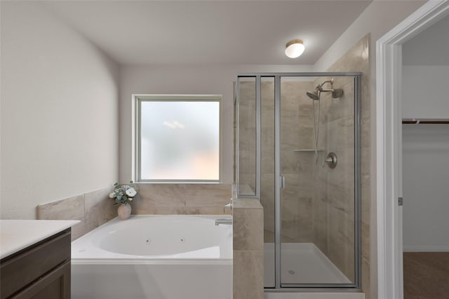 115 Clear Water St W, Montgomery, TX 77356 - full bathroom with a jetted tub, a shower stall, vanity, and a walk in closet