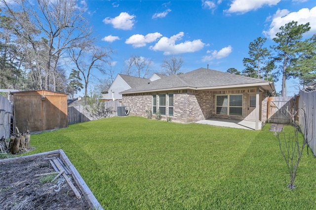 115 Clear Water St W, Montgomery, TX 77356 - back of property with a patio, brick siding, a shingled roof, and cooling unit