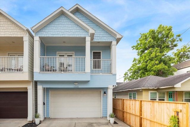 1115 E 27th St, Houston, TX 77009 - view of front of home featuring an attached garage, a balcony, and driveway
