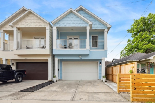 1115 E 27th St, Houston, TX 77009 - view of front of property featuring a garage, concrete driveway, a balcony, and stucco siding