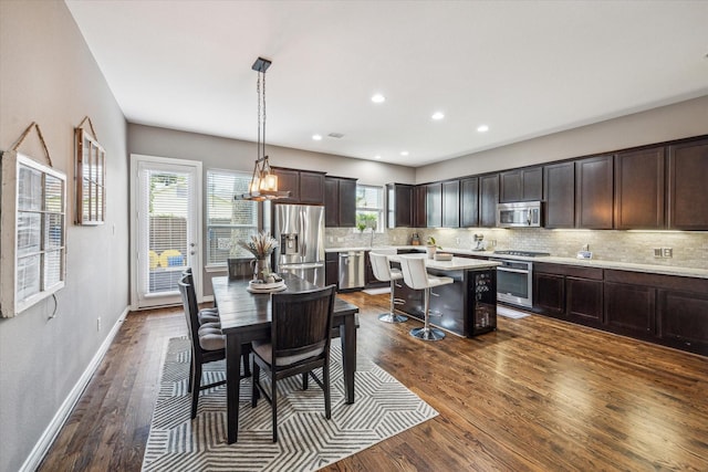 1115 E 27th St, Houston, TX 77009 - dining area featuring dark wood finished floors, baseboards, and recessed lighting