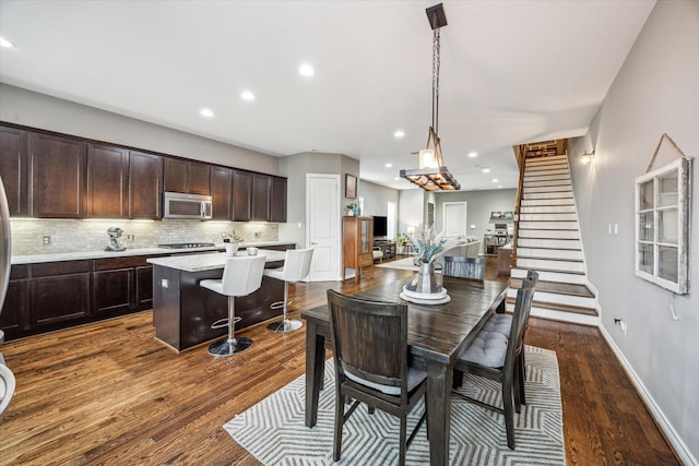 1115 E 27th St, Houston, TX 77009 - dining room with dark wood-style flooring, stairway, recessed lighting, and baseboards