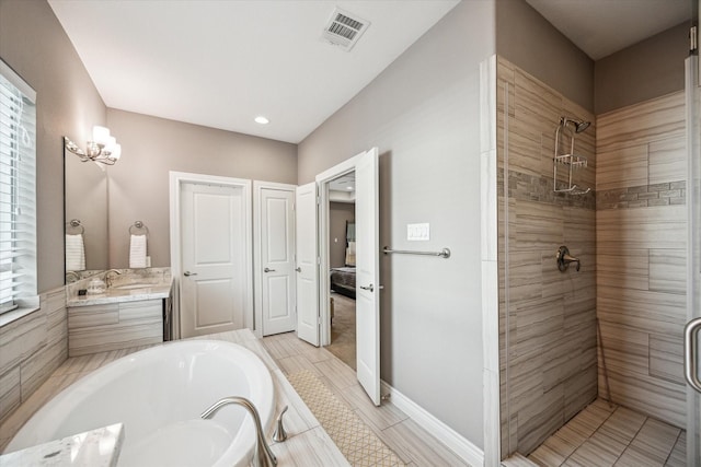 1115 E 27th St, Houston, TX 77009 - full bathroom with a tile shower, a garden tub, vanity, ensuite bathroom, and recessed lighting