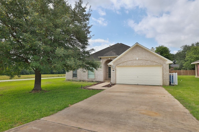 301 Redwood St, Prairie View, TX 77445 - view of front of home featuring driveway, a garage, and brick siding