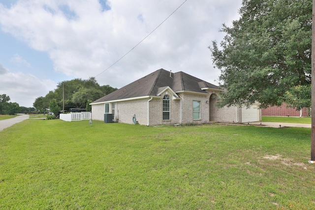 301 Redwood St, Prairie View, TX 77445 - view of front facade with central AC, brick siding, a garage, and roof with shingles