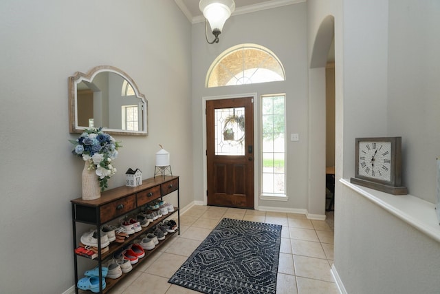 301 Redwood St, Prairie View, TX 77445 - tiled foyer with healthy amount of natural light, crown molding, arched walkways, a towering ceiling, and baseboards