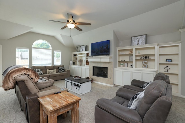 301 Redwood St, Prairie View, TX 77445 - living area with light colored carpet, a ceiling fan, a tile fireplace, and vaulted ceiling