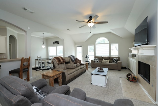 301 Redwood St, Prairie View, TX 77445 - living area featuring arched walkways, ceiling fan, a tile fireplace, light carpet, and lofted ceiling