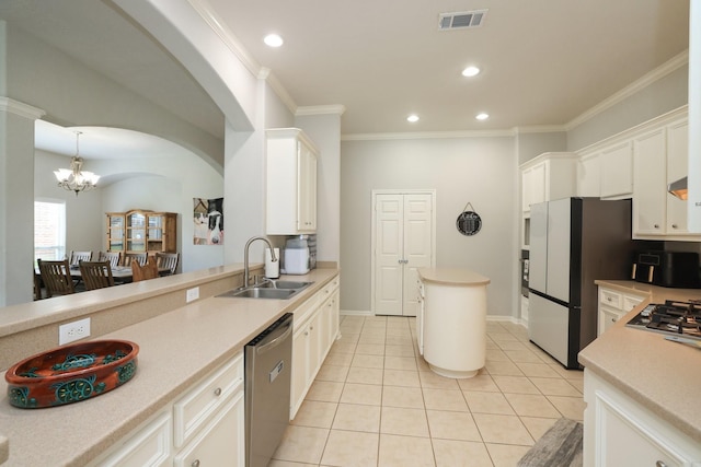 301 Redwood St, Prairie View, TX 77445 - kitchen featuring stainless steel appliances, a sink, a chandelier, light countertops, and light tile patterned floors