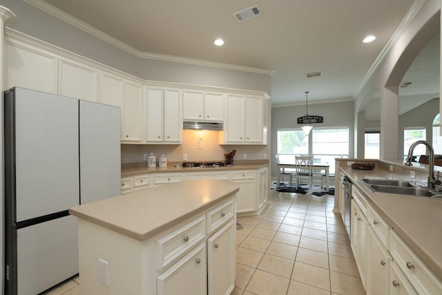 301 Redwood St, Prairie View, TX 77445 - kitchen featuring freestanding refrigerator, a sink, light countertops, white cabinetry, and crown molding