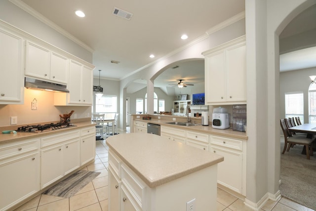 301 Redwood St, Prairie View, TX 77445 - kitchen featuring under cabinet range hood, stainless steel appliances, a sink, arched walkways, and ornamental molding