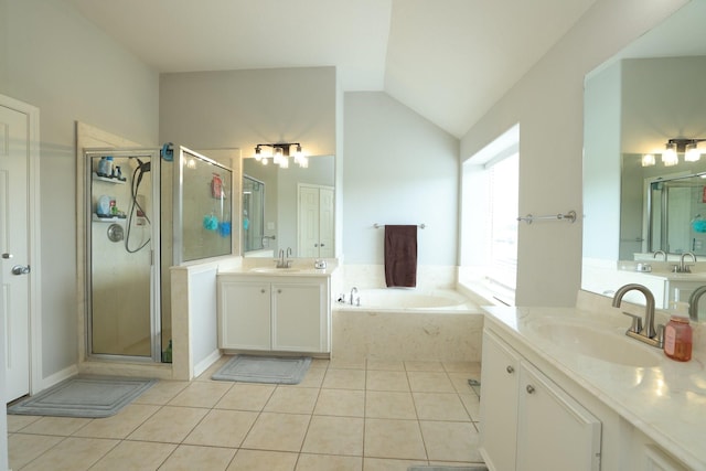 301 Redwood St, Prairie View, TX 77445 - bathroom with tile patterned flooring, a stall shower, a bath, two vanities, and lofted ceiling