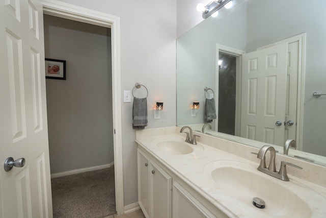301 Redwood St, Prairie View, TX 77445 - bathroom with double vanity and baseboards