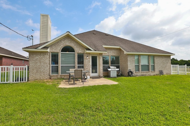 301 Redwood St, Prairie View, TX 77445 - back of property featuring a patio, brick siding, a chimney, and a shingled roof