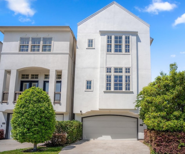 1217 E 28th St, Houston, TX 77009 - view of front facade with stucco siding, a garage, and concrete driveway