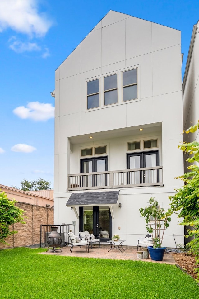 1217 E 28th St, Houston, TX 77009 - rear view of property featuring a balcony, a patio area, and stucco siding