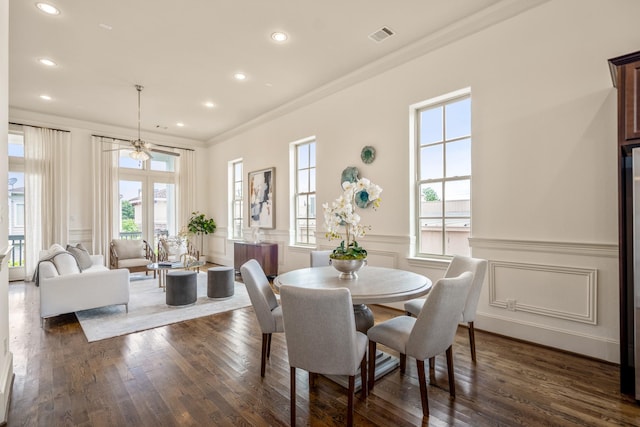 1217 E 28th St, Houston, TX 77009 - dining space with crown molding, a decorative wall, dark wood-style flooring, recessed lighting, and a wainscoted wall