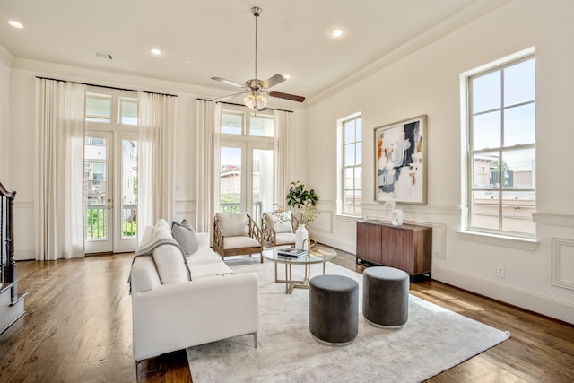 1217 E 28th St, Houston, TX 77009 - living room featuring plenty of natural light, crown molding, wood finished floors, radiator, and a ceiling fan