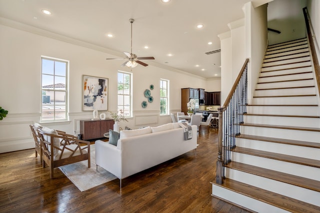 1217 E 28th St, Houston, TX 77009 - living area with radiator, ornamental molding, stairway, ceiling fan, and a wainscoted wall