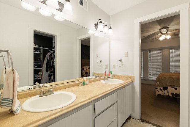 402 Teakwood Dr, Victoria, TX 77901 - ensuite bathroom with double vanity, a spacious closet, and ceiling fan