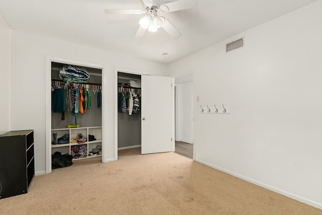 402 Teakwood Dr, Victoria, TX 77901 - bedroom featuring carpet flooring, multiple closets, baseboards, and a ceiling fan